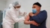 A man receives a dose of the Chinese-Uzbek ZF-UZ-VAC 2001 vaccine at a clinic in Tashkent on April 1.