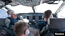 Sukhoi's chief civil test pilot, Aleksandr Yablontsev (left), and his crew sit in the cockpit of a Sukhoi Superjet during a flight on May 8, one day before the deadly crash in Indonesia.