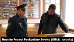 Dmitry Nikolayev (left) is being investigated in cases involving torture.