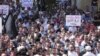 Kurdish antigovernment demonstrators march through the streets in the Syrian town of Qamishli in October.