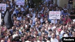 Kurdish antigovernment demonstrators march through the streets in the Syrian town of Qamishli in October.