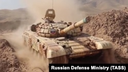 Russian tanks are deployed near the Afghan-Tajik border on July 20 ahead of military exercises next month.