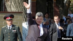 Ukrainian President Petro Poroshenko waves to cadets at a military academy in Kyiv on September 1. Poroshenko said the events of the past few days show Russia has launched a "direct and open aggression" against Ukraine. 