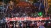 Demonstrators march against the "foreign agent" bill and to support Georgia's membership in the European Union in Tbilisi on May 24, with a banner reading "Serve Georgia."