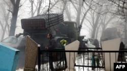 A pro-Russian separatists' Grad rocket launcher is parked in front of a cemetery in Donetsk on January 20, 2015