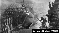 Is it 1945 all over again? Red Army soldiers hoist the Soviet flag over the Reichstag in Berlin at the end of World War II.