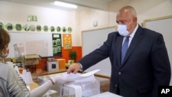 Bulgarian Prime Minister Boyko Borisov casts his ballot during parliamentary elections in the town of Bankya on April 4.