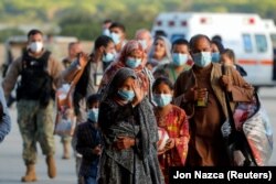 Afghan citizens evacuated from Kabul arrive at the Rota naval base in southern Spain on August 31, 2021.