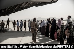 Evacuees wait to board a Boeing C-17 Globemaster III during an evacuation at Hamid Karzai International Airport in Kabul on August 30, 2021. "Losing such human capital, simply put, is disastrous," says one expert.