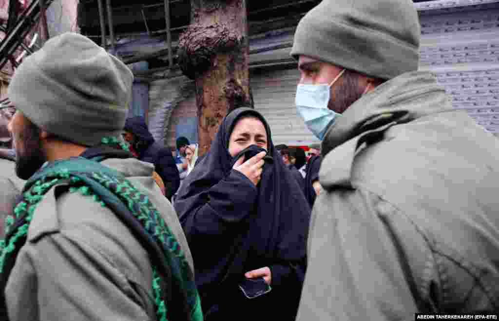 A woman mourns during the funeral of an Iranian security officer in Shahriar.&nbsp;