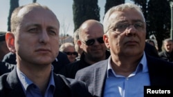 Montenegrin opposition leaders Milan Knezevic (left) and Andrija Mandic wait outside parliament on February 15. 