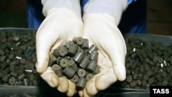 A worker at Kazakhstan's Ulba Metallurgical Works shows nuclear fuel pellets. Kazakhstan has found buyers for its uranium throughout Asia. 