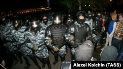 Riot police confront protesters during a rally against the construction of a church in central Yekaterinburg on May 14. 