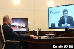 Russian President Vladimir Putin (left) in his office in Novo-Ogaryovo during a videoconference meeting with Gazprom head Aleksei Miller. (file photo)