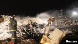 Emergencies Ministry members and firefighters work at the site of a Tatarstan Airlines Boeing 737 crash at Kazan airport on November 17.