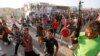 In Baghdad, members of a Shi'a militia parade through the streets.