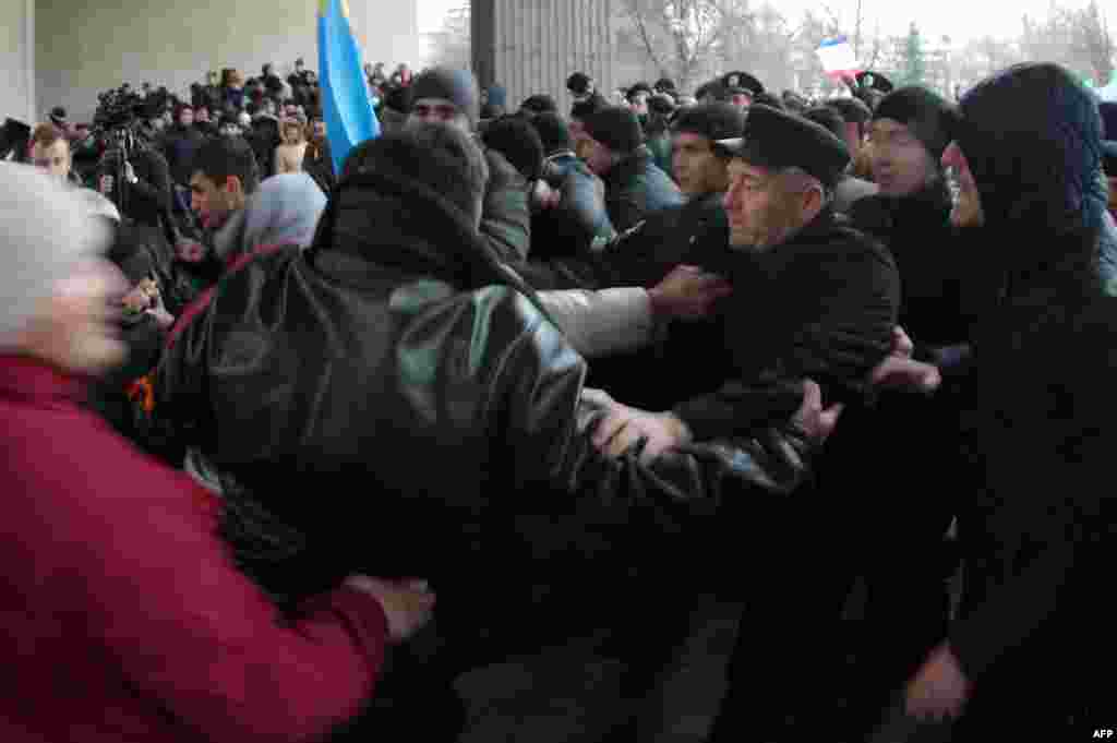 Pro-Ukrainian activists fight with pro-Russian activists.