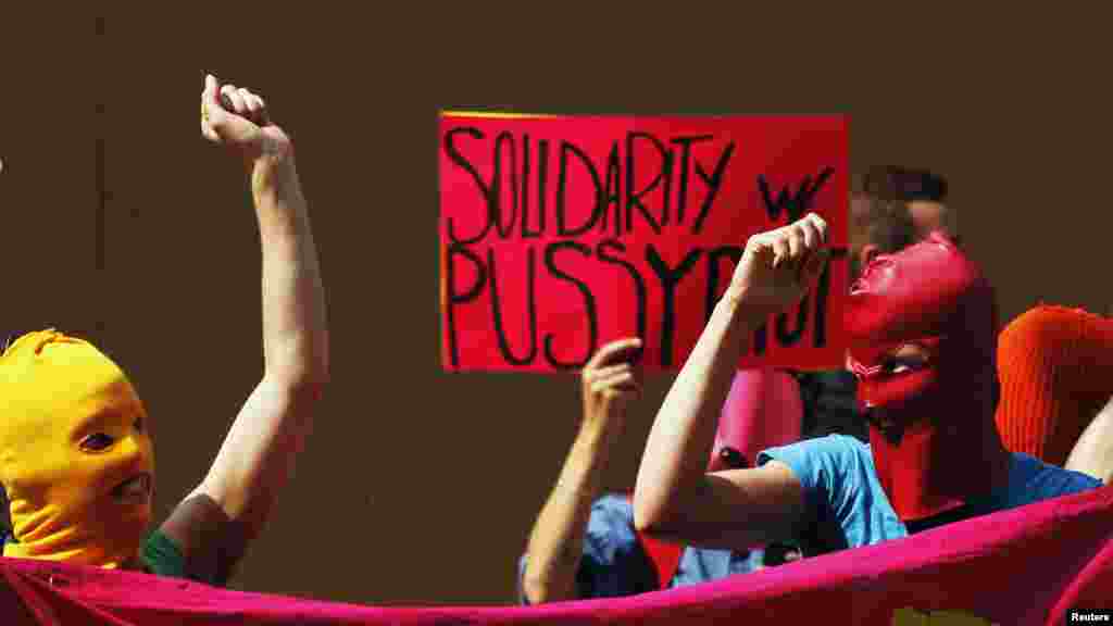 Demonstrators chant and raise their hands to show solidarity with Pussy Riot in front of the Russian Consulate in New York on August 17.