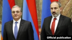 Armenian Prime Minister Nikol Pashinian (right) and then-Foreign Minister Zohrab Mnatsakanian attend an event in Yerevan in March 2019.