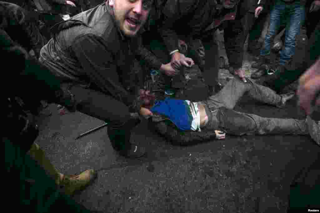 A man receives assistance after being injured in a stampede during the clashes.