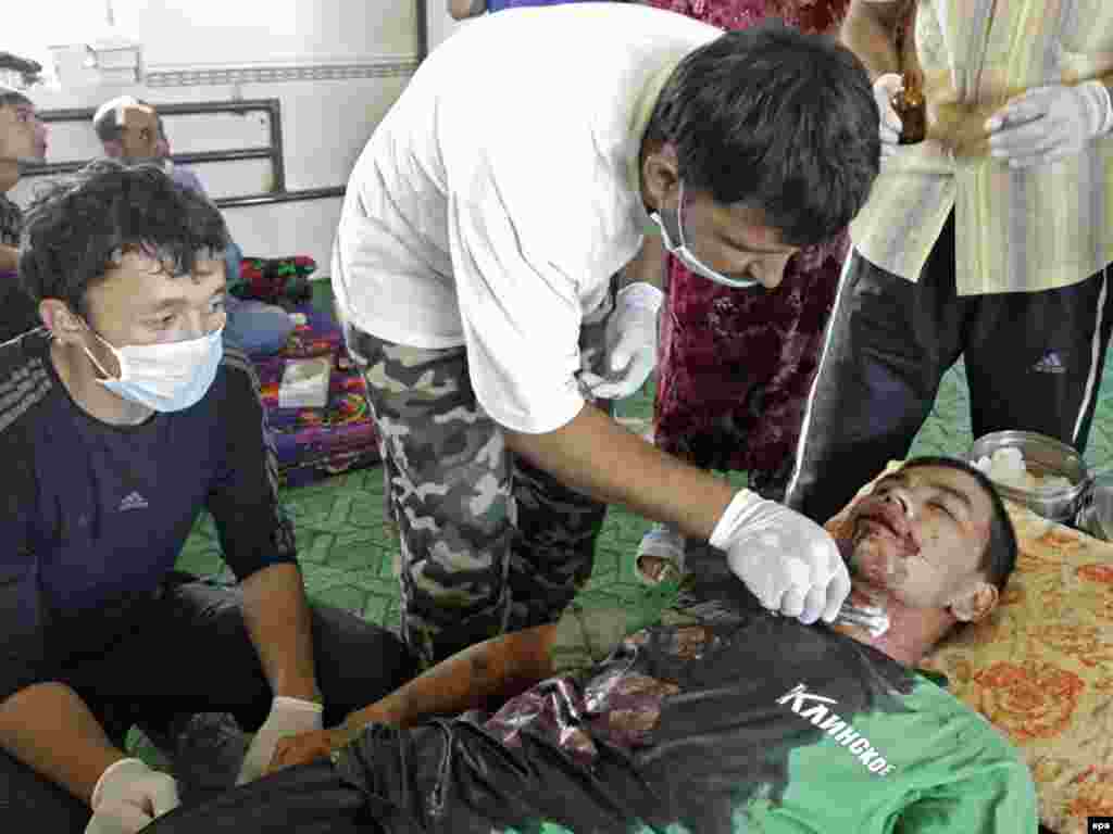 A doctor tries to save the life of a man wounded during ethnic clashes in the city of Osh on June 13.