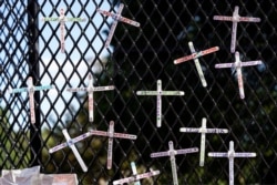 Crosses commemorating African-Americans who have died in police custody, as well as in other violent incidents, are placed on the fence surrounding the White House in Washington, D.C.