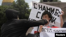 A man attacks an activist during a gay-pride parade in St. Petersburg last year, typical of the violence marchers face.