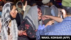 Afghan women at the scene of a rocket attack on Kabul Airport on August 26 that was claimed by the Islamic State.