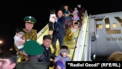 The plane delivering Tajik kids from Iraq arrives in Dushanbe on April 30.