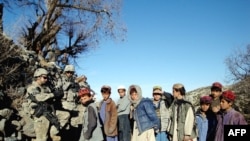 U.S. soldiers with Afghan children during a counternarcotics patrol in February 2009