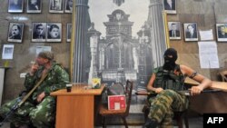 Word of the "partial withdrawal" of Russian forces near the Ukraine border came one day after pro-Russian fighters of the so-called Vostok (East) Battalion evicted Ukrainian separatists and occupied (pictured) the regional state building in the eastern city of Donetsk on May 29.