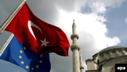 Turkish and EU flags fly in Istanbul. Garton Ash says the EU must fulfill its long-standing promises to Turkey -- and other countries that meet its criteria.