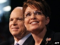 McCain stands with his controversial running mate Sarah Palin on the presidential campaign trail in August 2008.