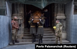 Soldiers carry the coffin of Ihor Baitala, a service member of the Ukrainian armed forces who was killed at the beginning of April in the fighting against Russia-backed separatists in the country's east, during a farewell ceremony in Lviv on April 10. More than 25 Ukrainian soldiers have been killed so far this year.