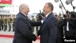 Belarusian President Alyaksandr Lukashenka (left) and his Azerbaijani counterpart, Ilham Aliyev, are both taken to task by the EU for the lack of human rights and press freedoms. (file photo)