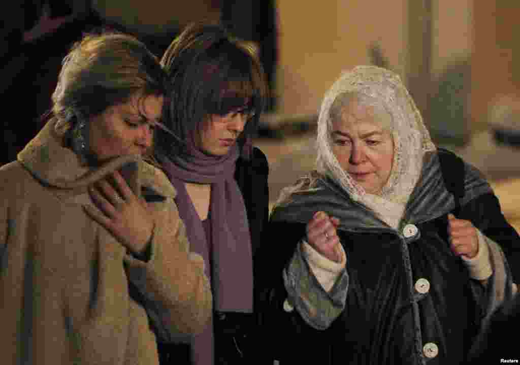 The former CEO's mother, Marina Khodorkovskaya (right), his wife Inna (left), and his daughter Anastasia walk out after a court hearing in Moscow on December 30, 2010. A judge sentenced Khodorkovsky to additional prison time on new charges of financial crimes. 