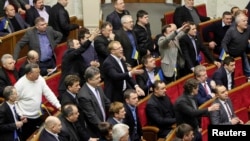 Ukrainian opposition deputies react during a session in parliament in Kyiv on January 29 in which the amnesty law was passed, without their participation.