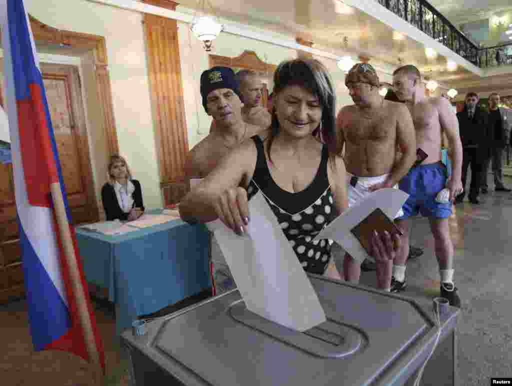 Member of the Polar Bear sports club casts their ballots in Barnaul, the capital of the Altai region.