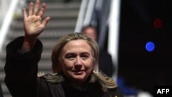 U.S. Secretary of State Hillary Clinton waves upon her arrival in Vilnius for an OSCE meeting.