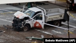 Police tape rests on a damaged Home Depot truck after a man drove onto a bike path near the World Trade Center memorial on October 31 in New York City.