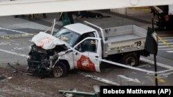 Police tape rests on a damaged Home Depot truck after a man drove onto a bike path near the World Trade Center memorial on October 31 in New York City.