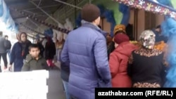 People wait in line to buy food at a market in Ashgabat in December 2019.