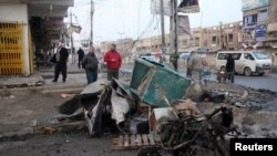 Iraqis inspect the site of a bomb attack in Baghdad, on January 14.