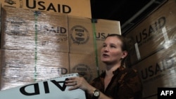 A USAID information officer shows American aid for Pakistani flood victims in 2010.