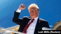 U.S. President Donald Trump pumps his fist as he arrives to attend the nearby G7 summit in Charlevoix after landing aboard Air Force One at Canadian Forces Base Bagotville in La Baie, Quebec, Canada, on June 8.