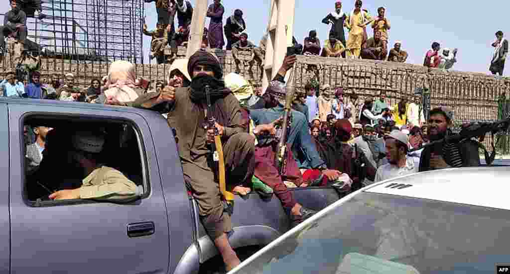 Taliban fighters sit on a vehicle along the street in Jalalabad. The eastern city fell to the militants early on August 15, reportedly with no resistance.