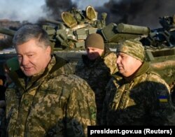 Ukrainian President Petro Poroshenko (left) and Defense Minister Stepan Poltorak (right) visit a training center of the Ukrainian Army's ground forces in the Chernihiv region, which is under martial law, on November 28.