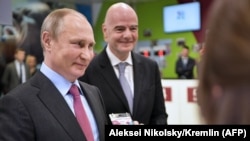 Russian President Vladimir Putin (left) poses with his FAN ID for the 2018 FIFA World Cup Russia as FIFA President Gianni Infantino stands nearby in Sochi last month.