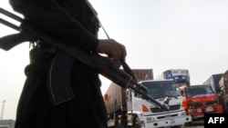 Pakistani security personnel escort trucks loaded with supplies for NATO and U.S.-led forces in Afghanistan, at the Pakistani border town of Jamrud last month.