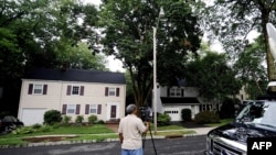 Members of the media stand in front of the home at 31 Marquette Road in Montclair, New Jersey, of two of the accused Russian spies.